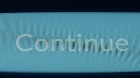 Finger taps the Continue button, macro view Stock Footage 309403773