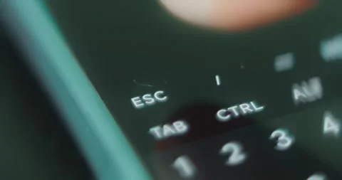 Finger taps the ESC escape button on digital keyboard Stock Footage 313621895