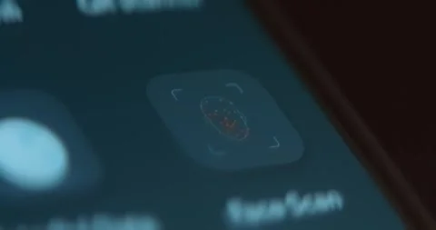 Finger taps the Face Scan icon on smartphone screen Video stock 323387751