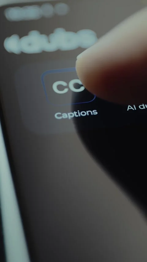 Finger taps the option to enable Closed Captions within an application 動画素材 328367754