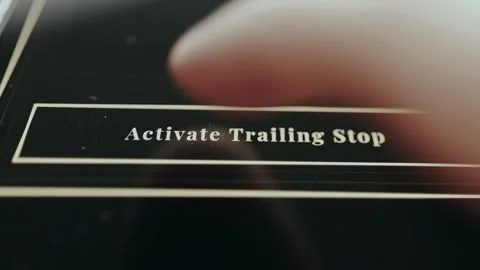 Finger taps the option labeled Activate Trailing Stop 스톡 동영상 331592318