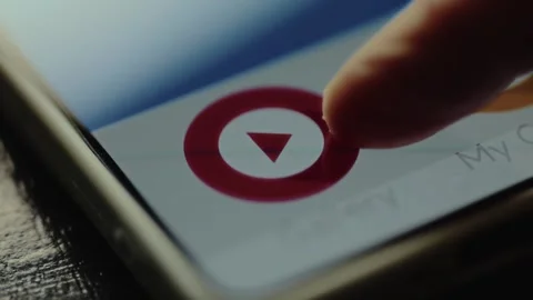 Finger taps a play button icon on a smartphone screen Stock Footage 327451051