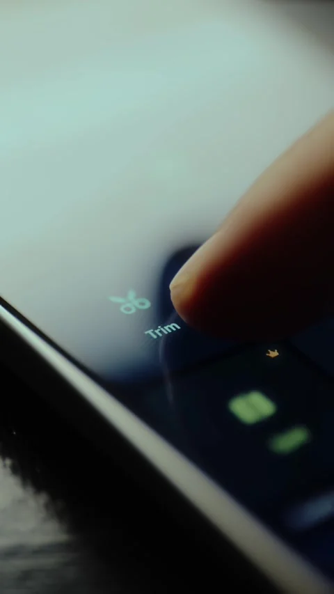 Finger taps the Trim function within a video editing application Stock Footage 326947262