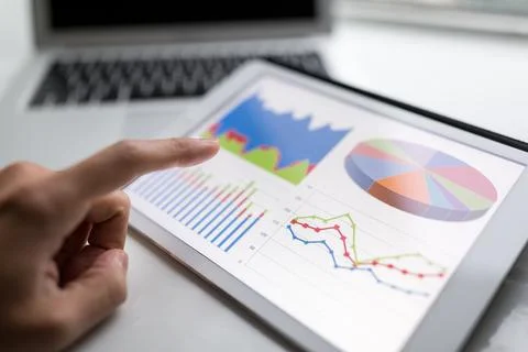 Finger touch on Digital tablet computer to show the chart Stock Photos