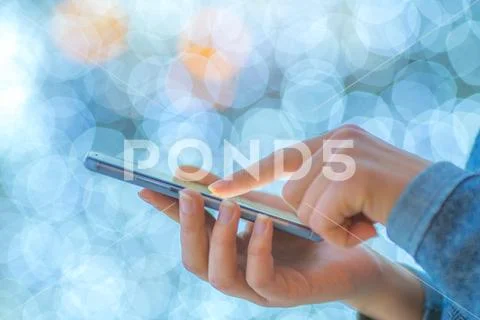 The finger touch mobile screen on the background of lights Stock Photos