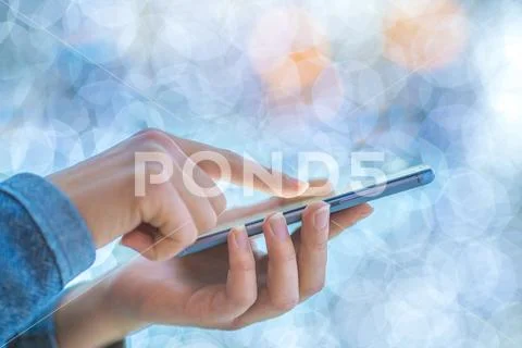 The finger touch mobile screen on the background of lights Stock Photos