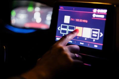 Finger on the touch screen of the computer in the car Stock Photos