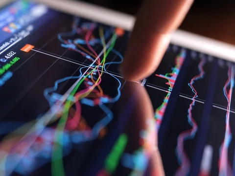 Finger touch on tablet computer screen with stock market graph Stock Footage