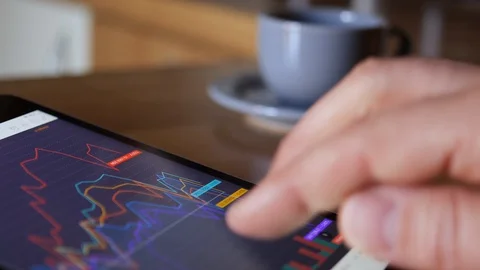 Finger Touch On Tablet Computer Screen With Stock Market Graph, coffe break. 스톡 동영상 127819559