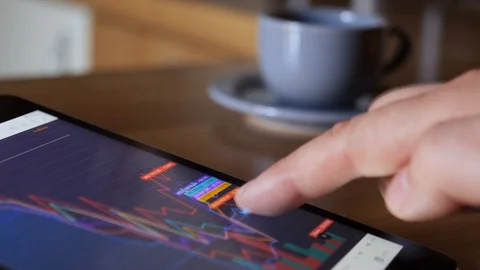 Finger Touch On Tablet Computer Screen With Stock Market Graph, coffe break. 스톡 동영상 127819614