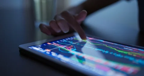Finger touch on tablet computer with stock market data Stock Footage 113693619