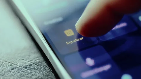 Finger is touching the app icon labeled Equalizer on a smartphone screen Stock Footage 326945554