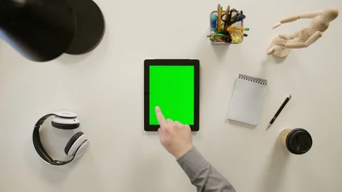 A Finger Touching a Green Screen of the iPad Stock Footage 86092240