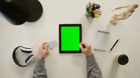 A Finger Touching a Green Screen of the iPad Stock Footage 86096412