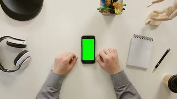 A Finger Touching a Green Screen of the Smartphone Stock Footage 86098686