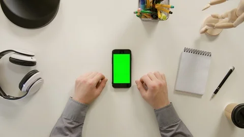 A Finger Touching a Green Screen of the Smartphone Stock Footage 86098809