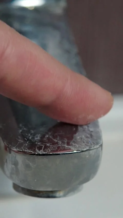 Finger Touching Limescale Deposit on Bathroom Faucet Stock Footage 345206257