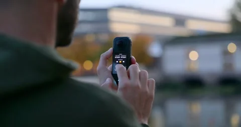 Finger touching menu interface on screen of Insta360 action camera Stock Footage 340555195