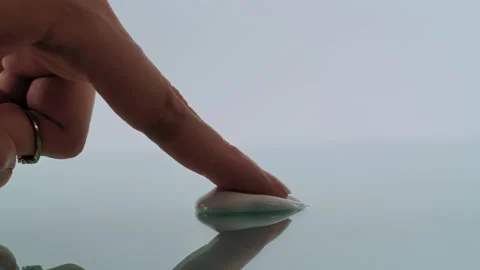 Finger Touching Modern Spoon on Smooth Surface Minimalistic View Stock Footage 312377882