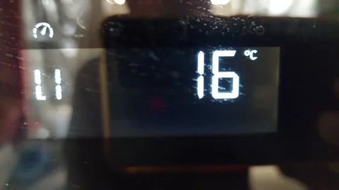 Finger Touching Power Button on Digital Display with Temperature Settings Vídeos de archivo 333644284