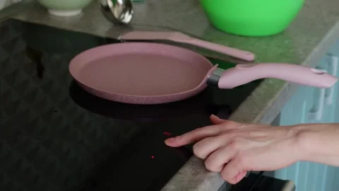 Finger touching sensor button on induction hob. Stock Footage 273531267