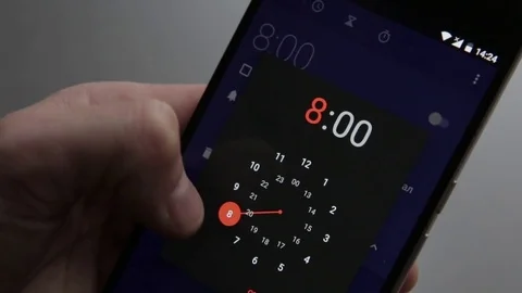 Finger touching a smartphone with a touch screen to tern on  alarm clock Stock Footage 70140974