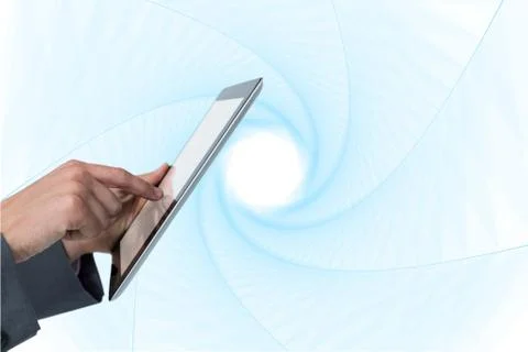 Finger touching tablet computer screen against abstract background Stockfoto's
