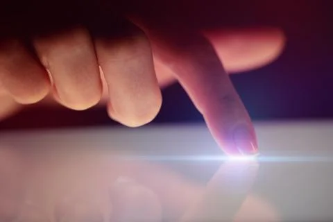 Finger touching tablet with dark background Stockfoto's