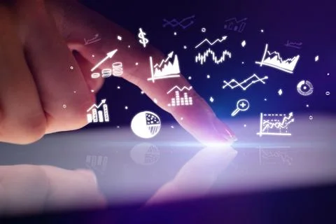 Finger touching tablet with reports and charts above Stock Photos