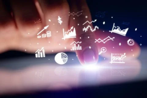 Finger touching tablet with reports and charts above Stock Photos