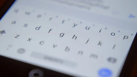 Finger touching virtual keys form a digital keyboard of a touchscreen phone Stock Footage 71294513
