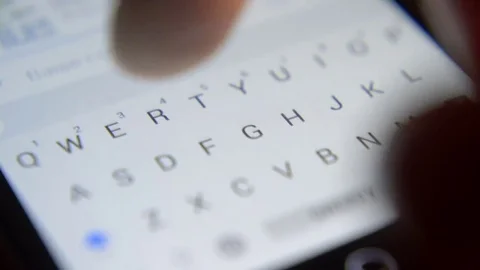 Finger touching virtual keys form a digital keyboard of a touchscreen phone 스톡 동영상 71294571