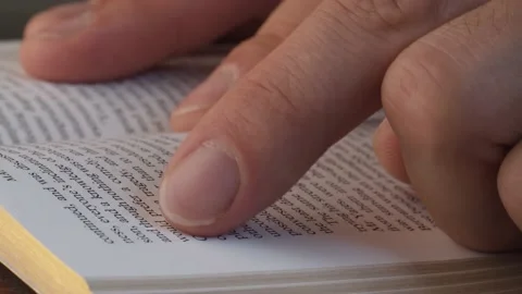 Finger traces the lines in the book Video stock 140315972