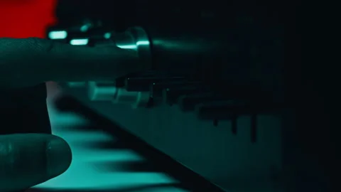 Finger triggering buttons recorder in dim studio closeup. Macro view man hand Stock Footage 332674623