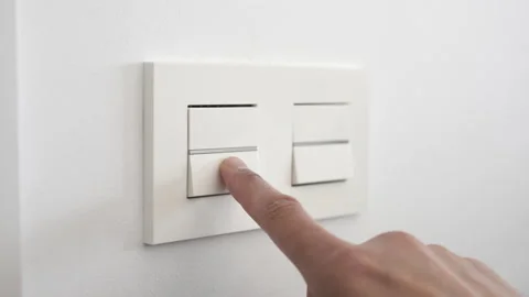 Finger is turn on or off on light switch with white wall at home Stock-Footage 189803463