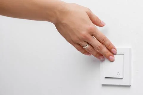 Finger turning off light switch Stock Photos