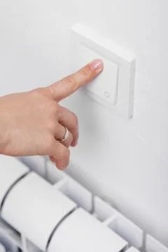 Finger turning off light switch Stock Photos