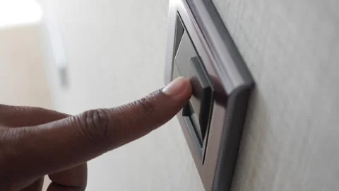A finger turning on lighting switch . Stock Footage 251409669