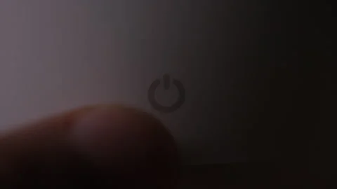 Finger turning on a power button as it continues to glow Stock Footage 219354895