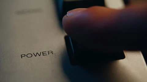 Finger turning off power button on retro device closeup. Man pushing knob Stock Footage 332617910