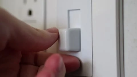 Finger turning a shredder switch on and off in slow motion Stock Footage 306193340