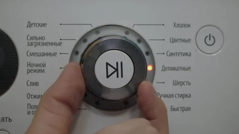 Finger turning washing machine control dial Stock Footage 342863593
