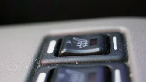 The finger turns on the seat heating button in the car close-up Stock Footage 169694791