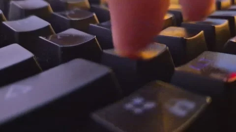 A finger typing on a black, mechanical gaming keyboard Stock Footage 338427376