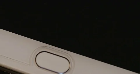 Finger unlocking a smartphone fingerprint sensor Stock Footage 77281981