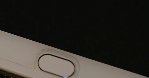 Finger unlocking a smartphone using the fingerprint scanner Stock-Footage 77281805