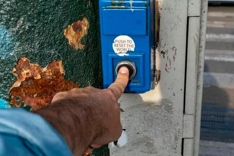 Finger while presing push to reset world button Stock Photos