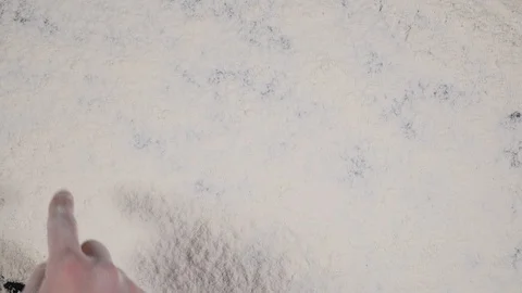 Finger write AGAIN on a white flour background. top view 4k Stock Footage 91974587