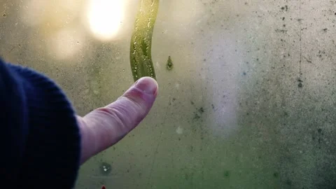 Finger writing in the condensation on window Video stock 255727749