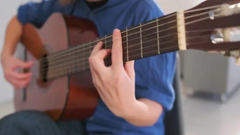 Fingerpicking exercise on classical guitar, close-up of woman hand Video stock 314483199